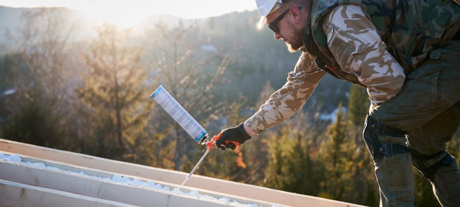 professional installing spray foam insulation on roof